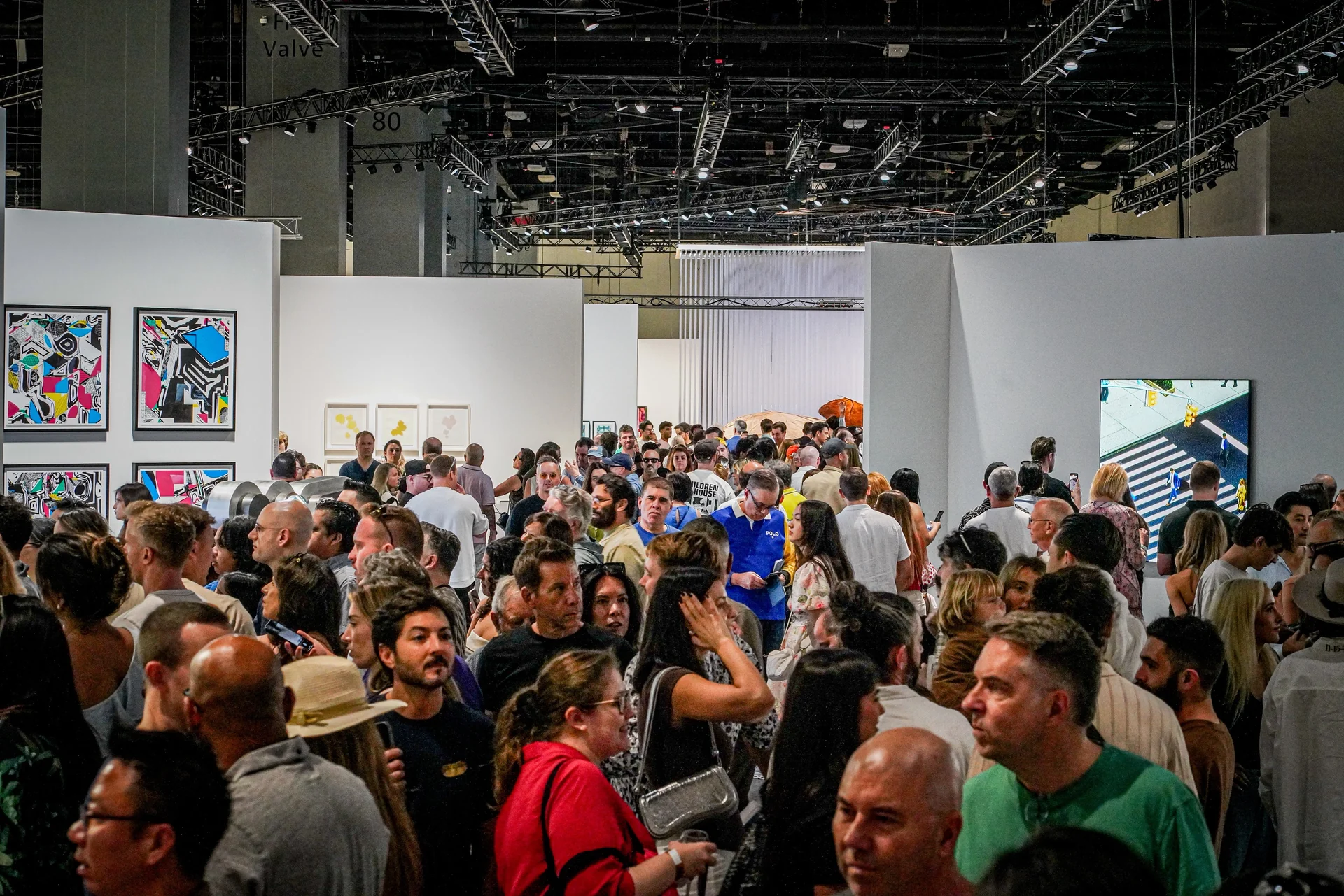 A crowd of visitors in the Zero 10 sector, with Polygon Etcetera prints and Floor Ringer visible on the left.