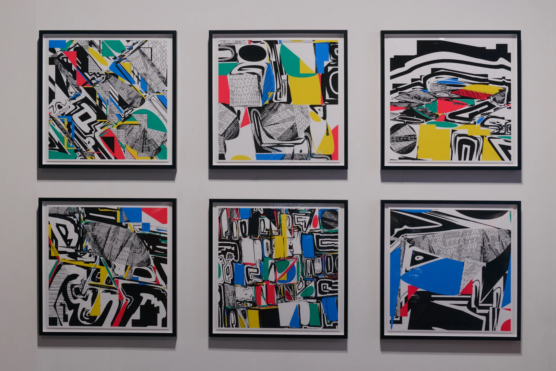 Six framed Polygon Etcetera prints arranged in two rows on the left wall of the booth.