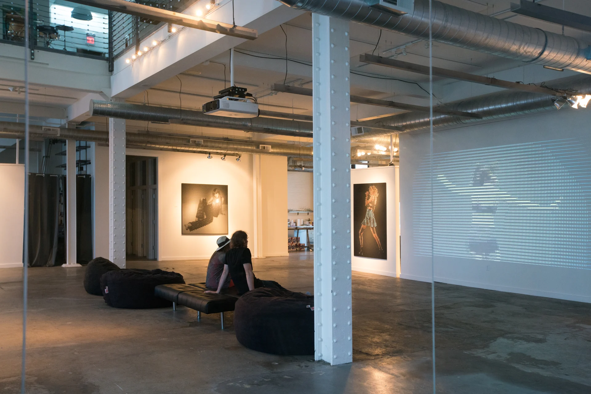Visitors watching the ASCII projection at Heron Arts.