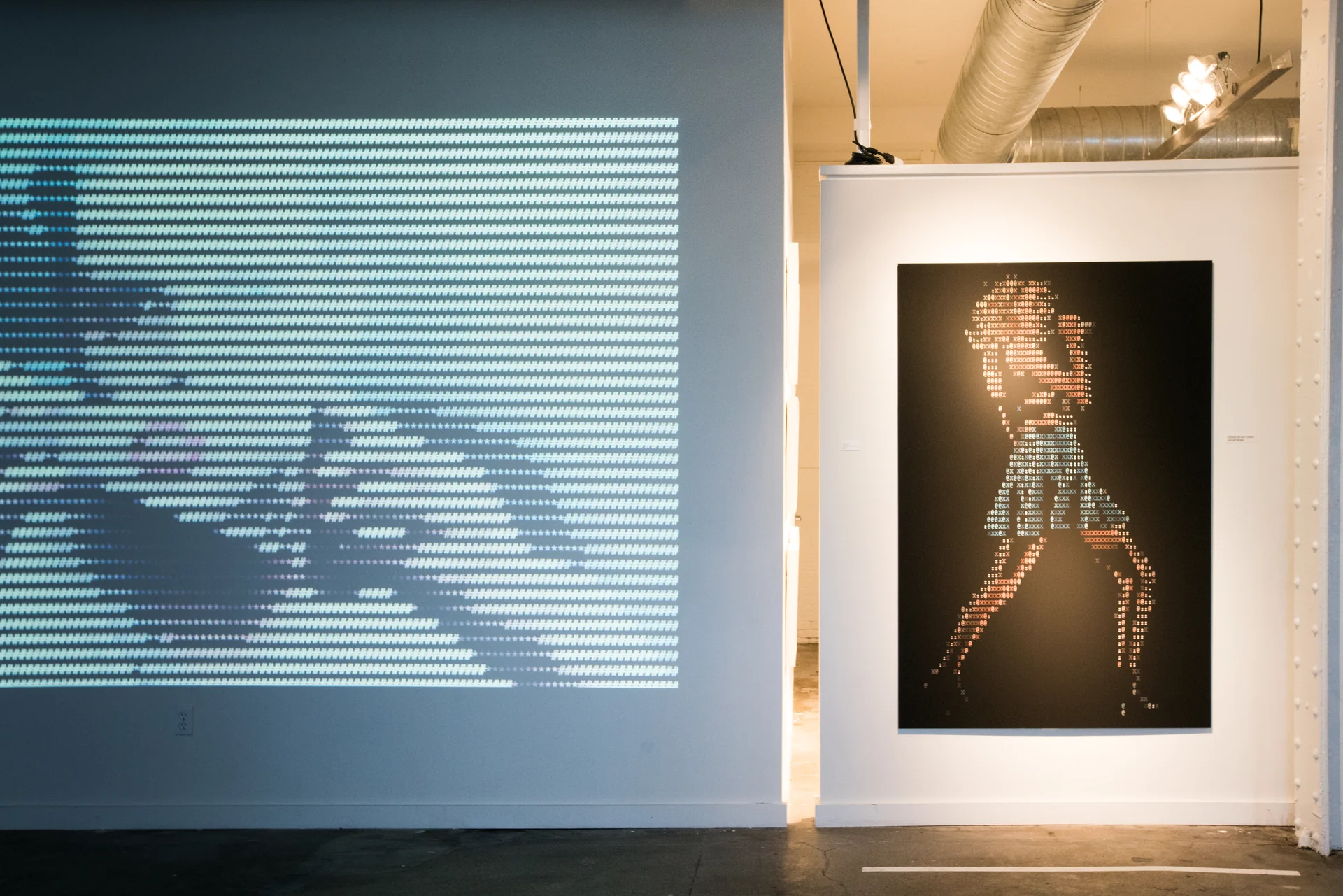 A projected image alongside a large ASCII portrait.