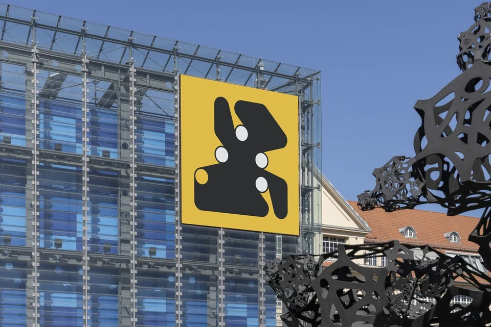 Ringers #324 displayed on the outdoor LED screen of the ZKM Cube, with the museum’s glass facade and a sculpture in the foreground. Photograph by Elias Siebert, ZKM Karlsruhe.