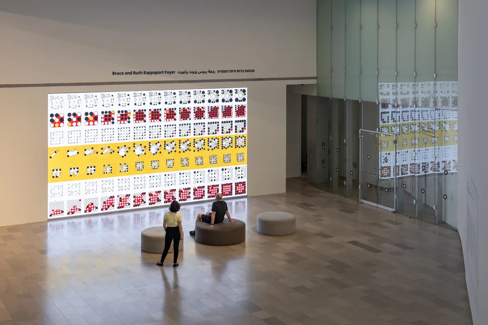 An elevated view of the installation showing rows of yellow, red, black, and white Ringers.