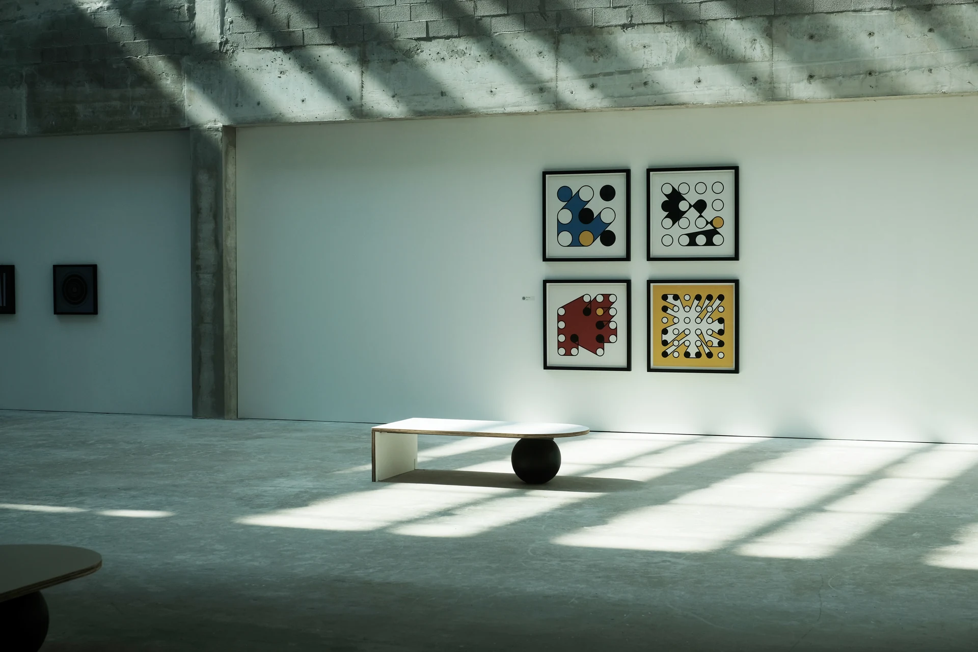 Four framed Ringers arranged in a two-by-two grid in a sunlit gallery in Miami Beach.