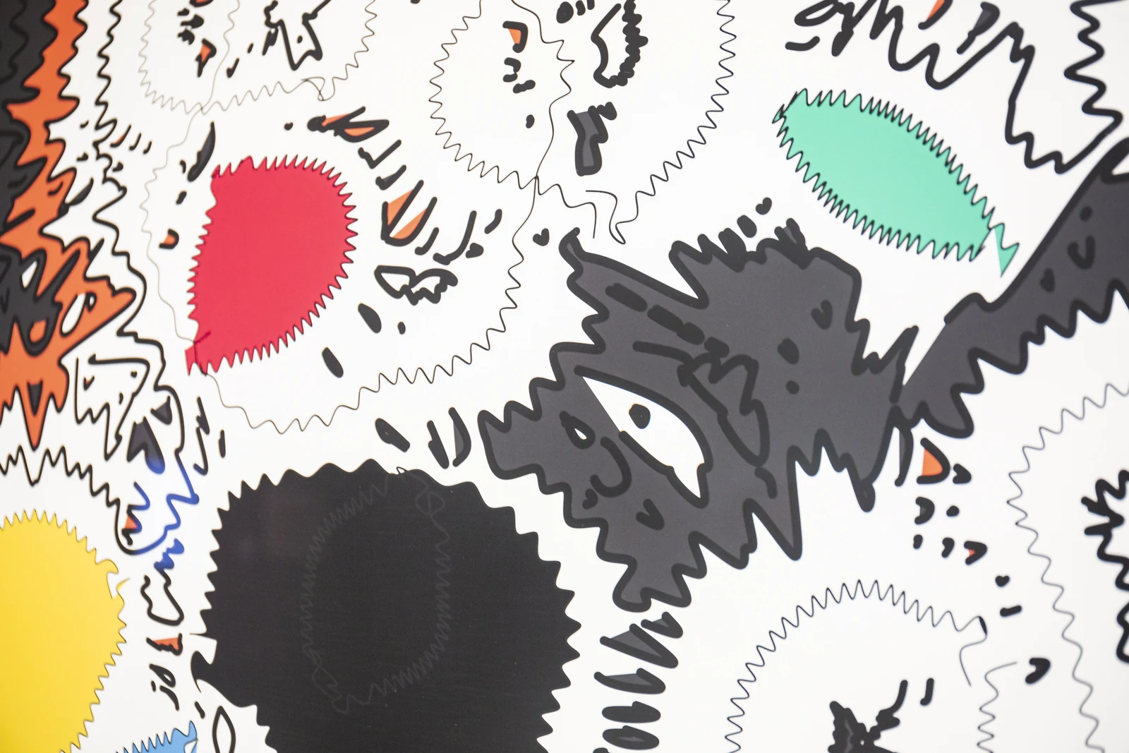 A close-up of rippling black contours surrounding pink, green, yellow, and orange forms in the print.